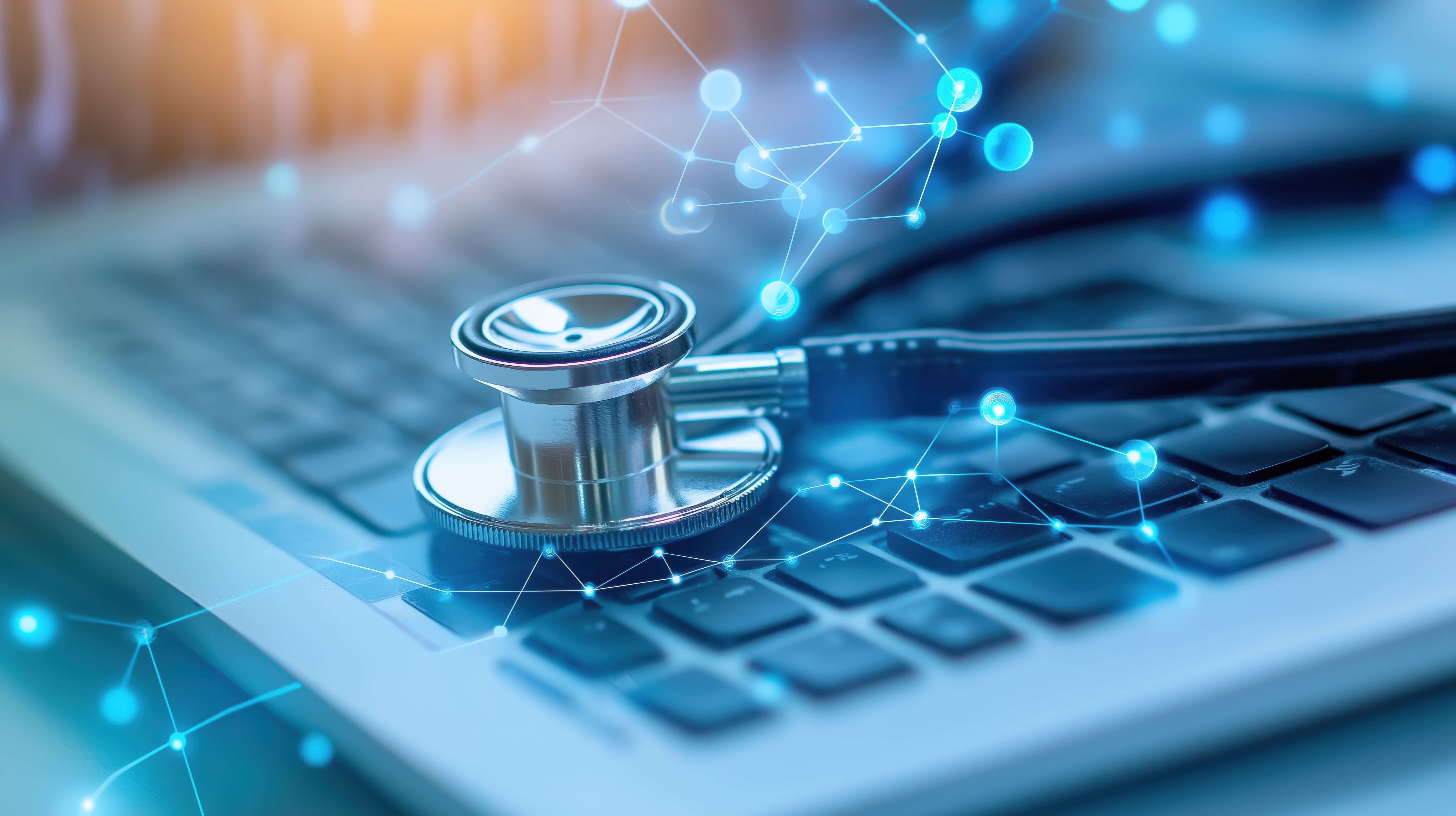 A stethoscope rests on a laptop keyboard, symbolizing the intersection of healthcare and technology in modern medicine.