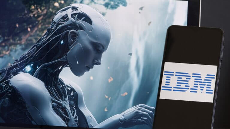 IBM logo displayed on smartphone, Artificial Intelligence working in the background on computer screen, IBM to Pause Hiring or eliminating Positions and Jobs That AI Could Do, USA, June 22, 2023