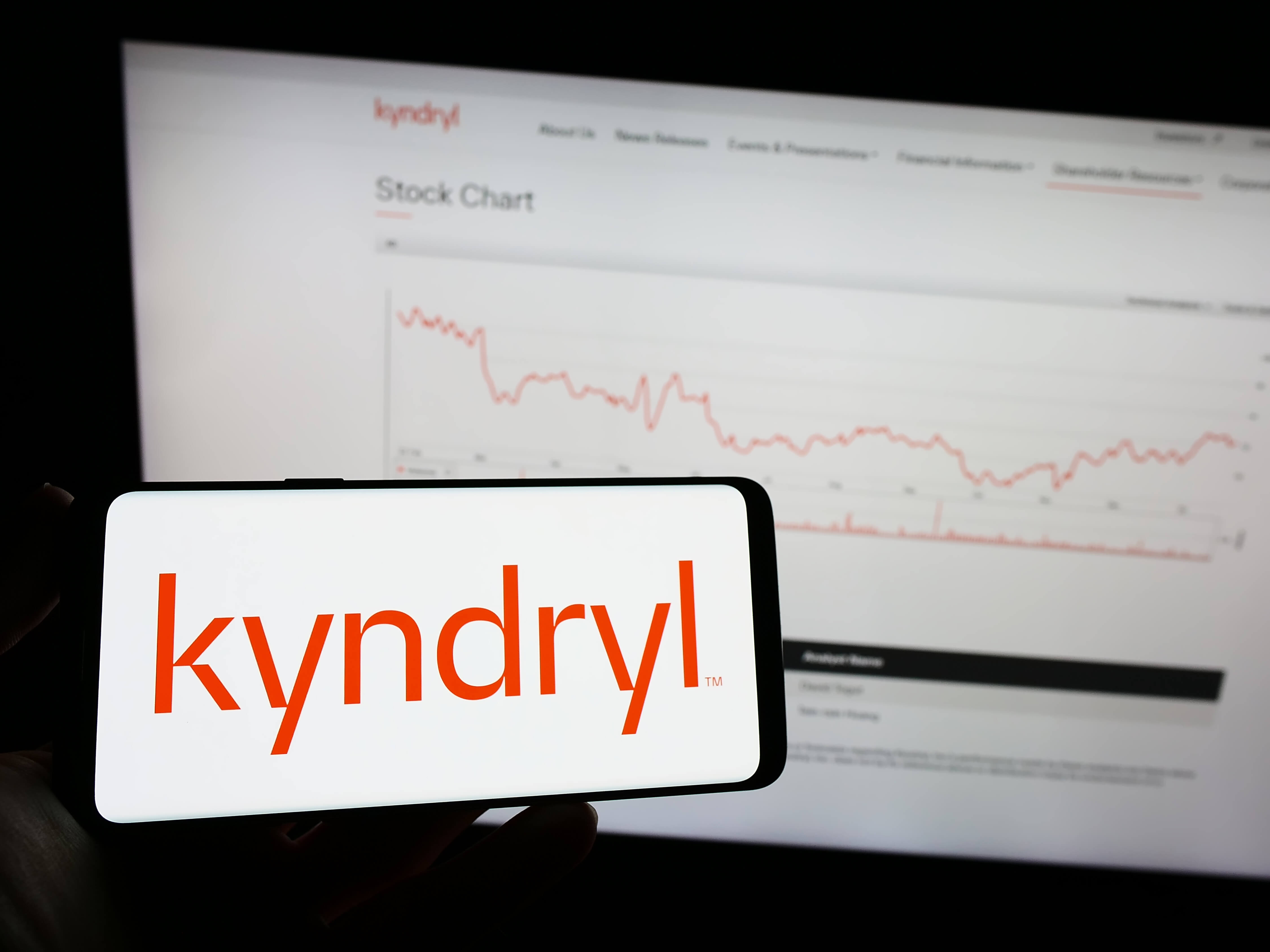 Stuttgart, Germany – 01-22-2023: Person holding mobile phone with logo of technology company Kyndryl Holdings Inc. on screen in front of business web page. Focus on phone display.