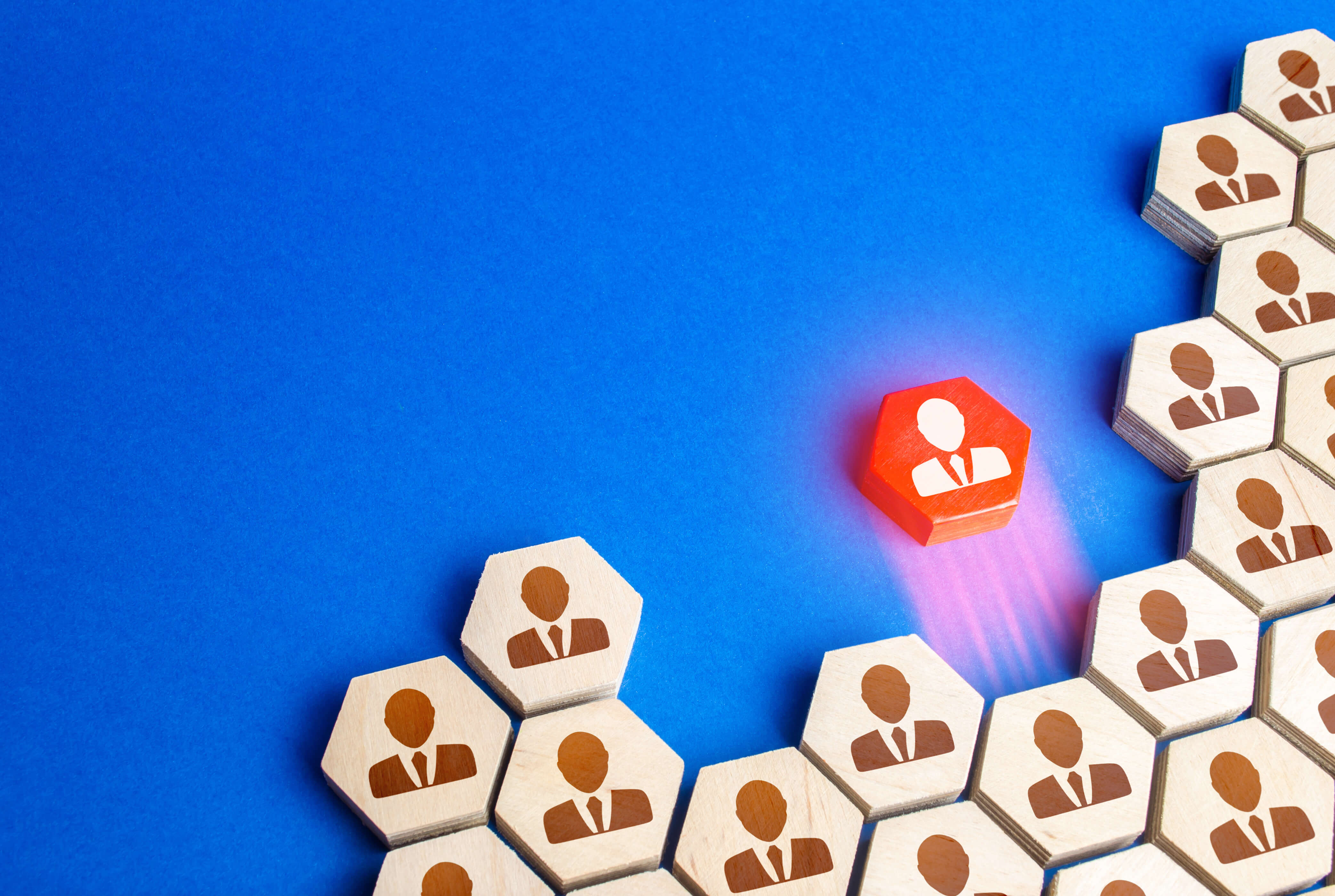 Red figurine of the employee leaves company of people. Leakage of valuable workers. Toxicity and conflict in the team. Leadership qualities, start your own business. Staff reduction. Talented worker